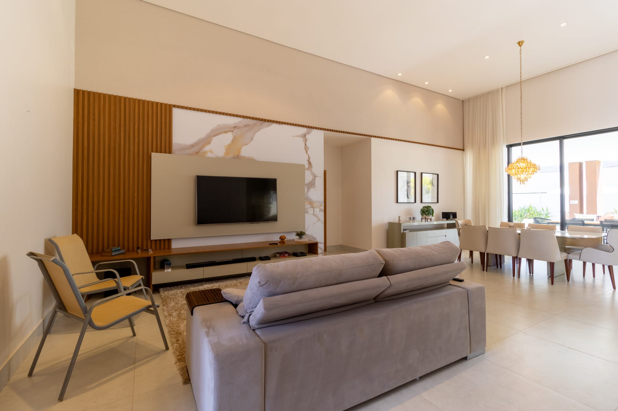 Living room with grey sofa, slatted timber wall and marble panel