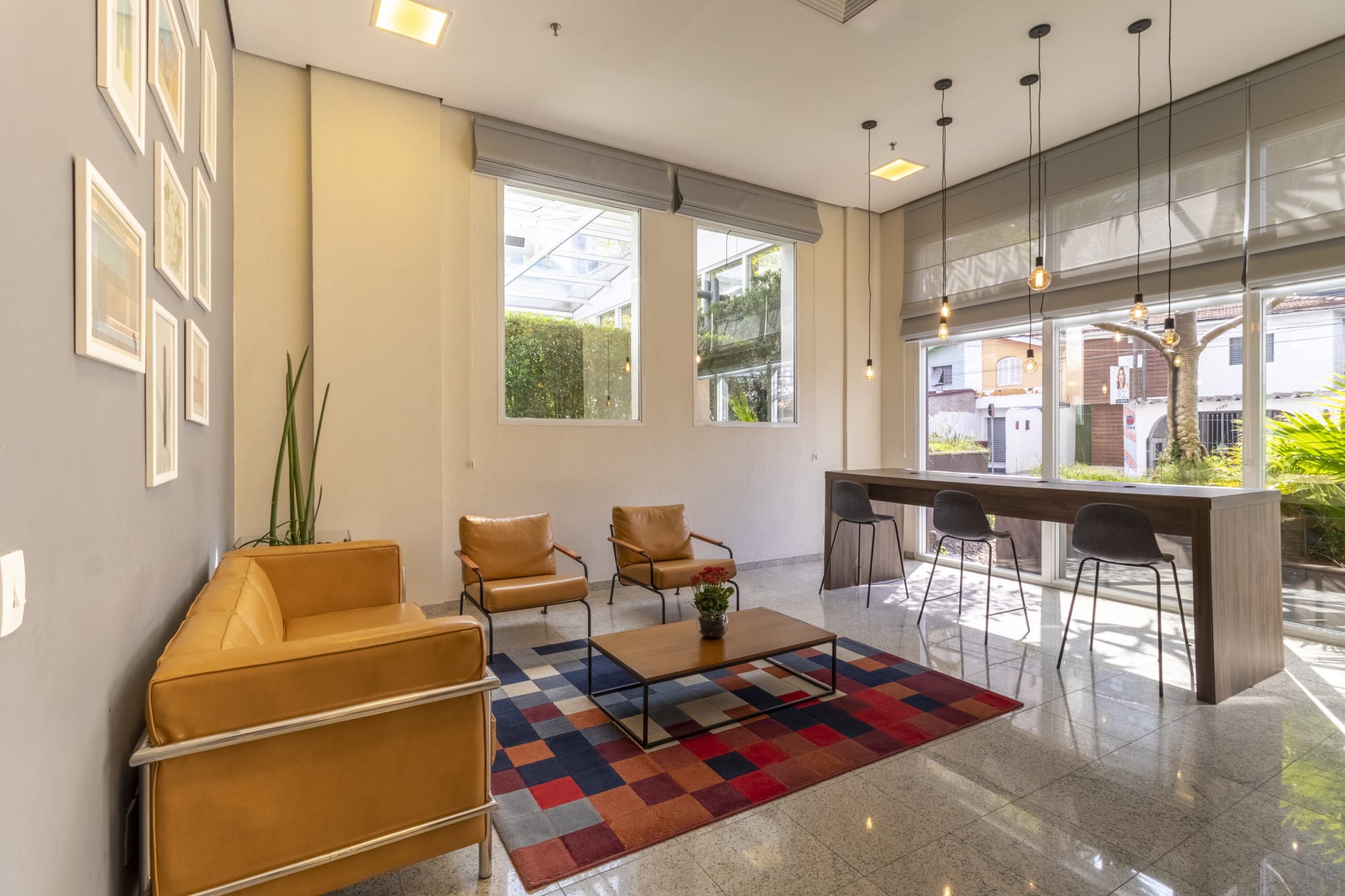 Lobby lounge with mustard sofa, patchwork rug and high bar table