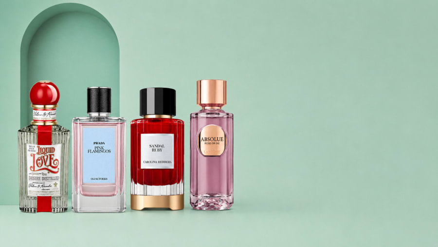 Four perfume bottles lined up before a mint arched niche for El Palacio de Hierro