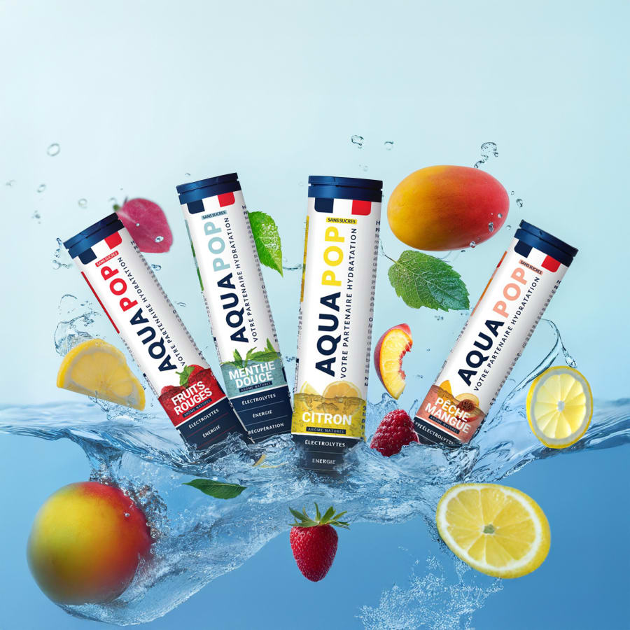 Four Aquapop flavour tubes splashing into water with lemon, mango, strawberry and mint