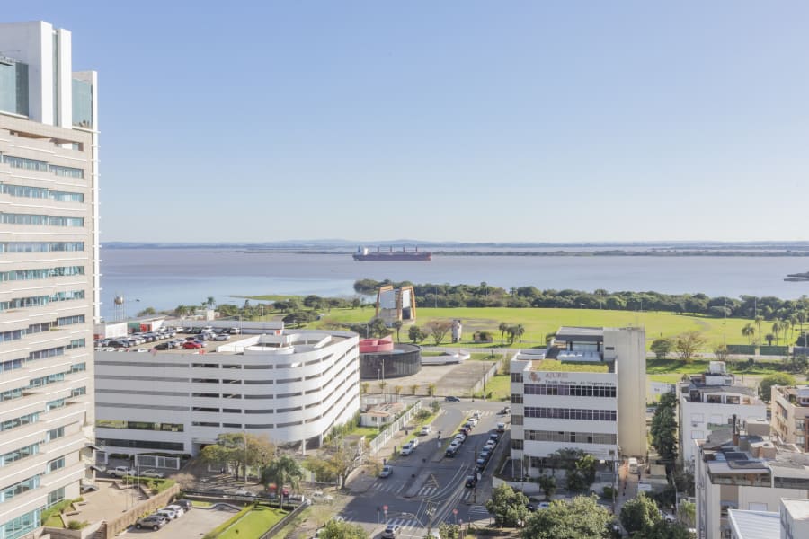 High view over Porto Alegre towers and green waterfront toward the Guaíba