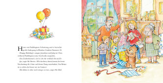 Paddington feiert Geburtstag bei Familie Brown. Um ihn herum stehen Geschenke, und er freut sich über einen Zauberkasten.