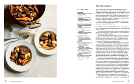 Rinderschmorgericht mit Karotten, Pilzen und kleinen Zwiebeln in dunkler Sauce, serviert in tiefen Tellern.