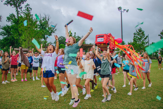 campers jumping with confetti falling around them