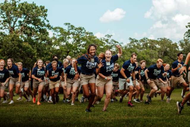 Summer staff running toward the camera excited to start a new week