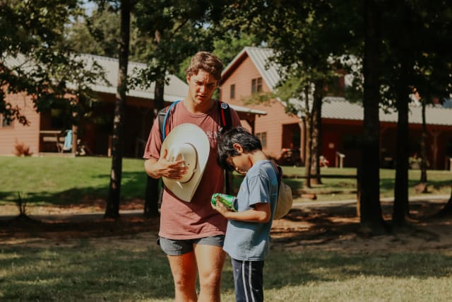 A summer staff prays with his camper