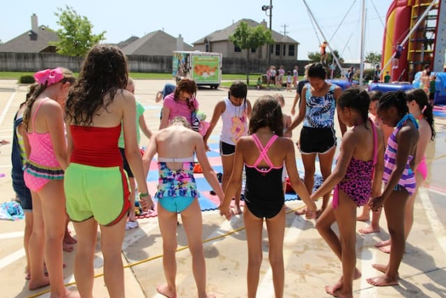 Girls pray together with counselor at Fellowship of the Parks.