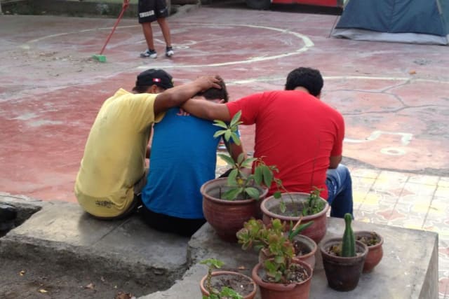 Men Praying at Camp Peru
