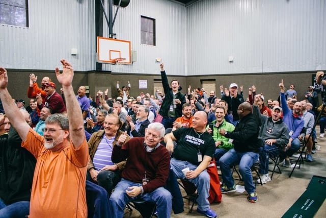 Men worshiping at conference