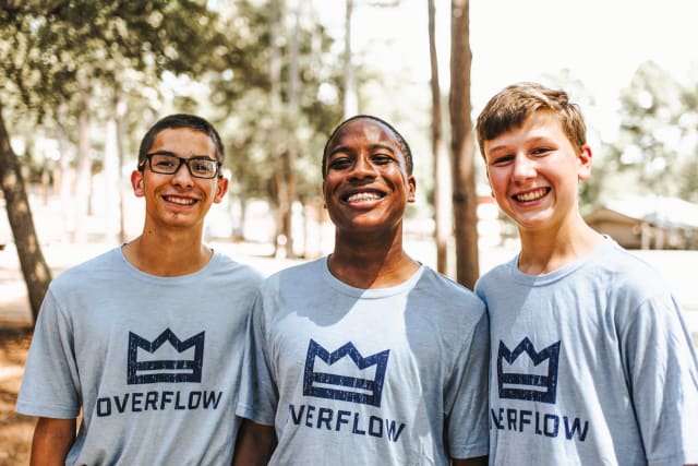 A group of guy two-week campers laughing together