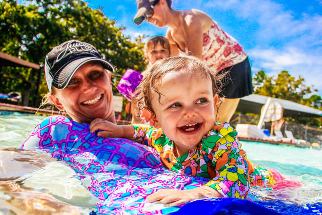 mother and daughter playing in the pool