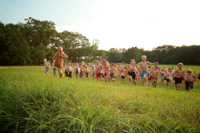 campers running up a hill