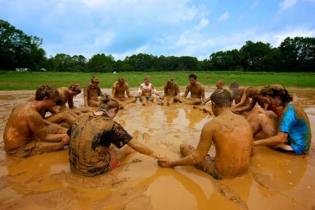 Campers praying in the mud