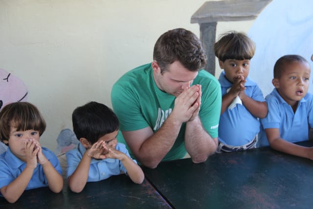 Forge Member Praying with Kids