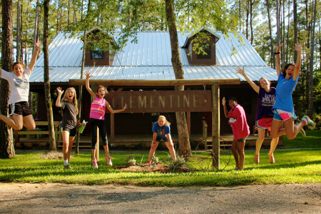 Ranch Cabins with girl campers jumping