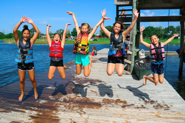 group of campers jumping together