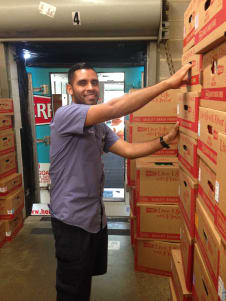 Route Sales employee pulling boxes from the back of a route truck
