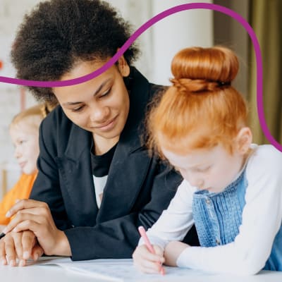 Adult watching child draw