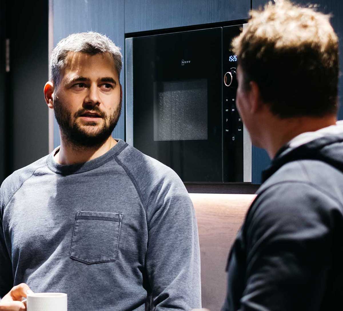 Team members talking in the kitchen