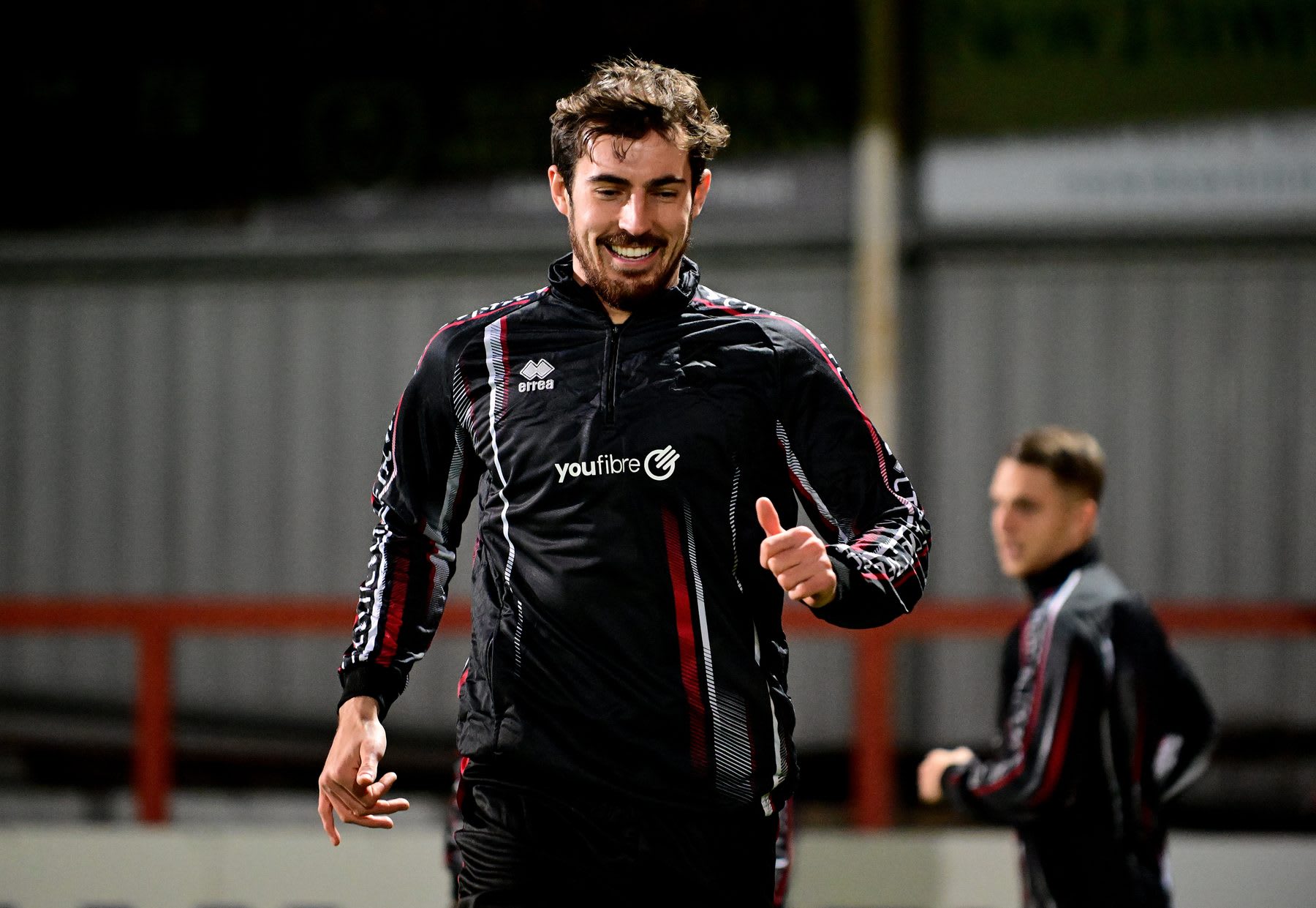 A player from a YouFibre-sponsored football club giving a thumbs up in training kit