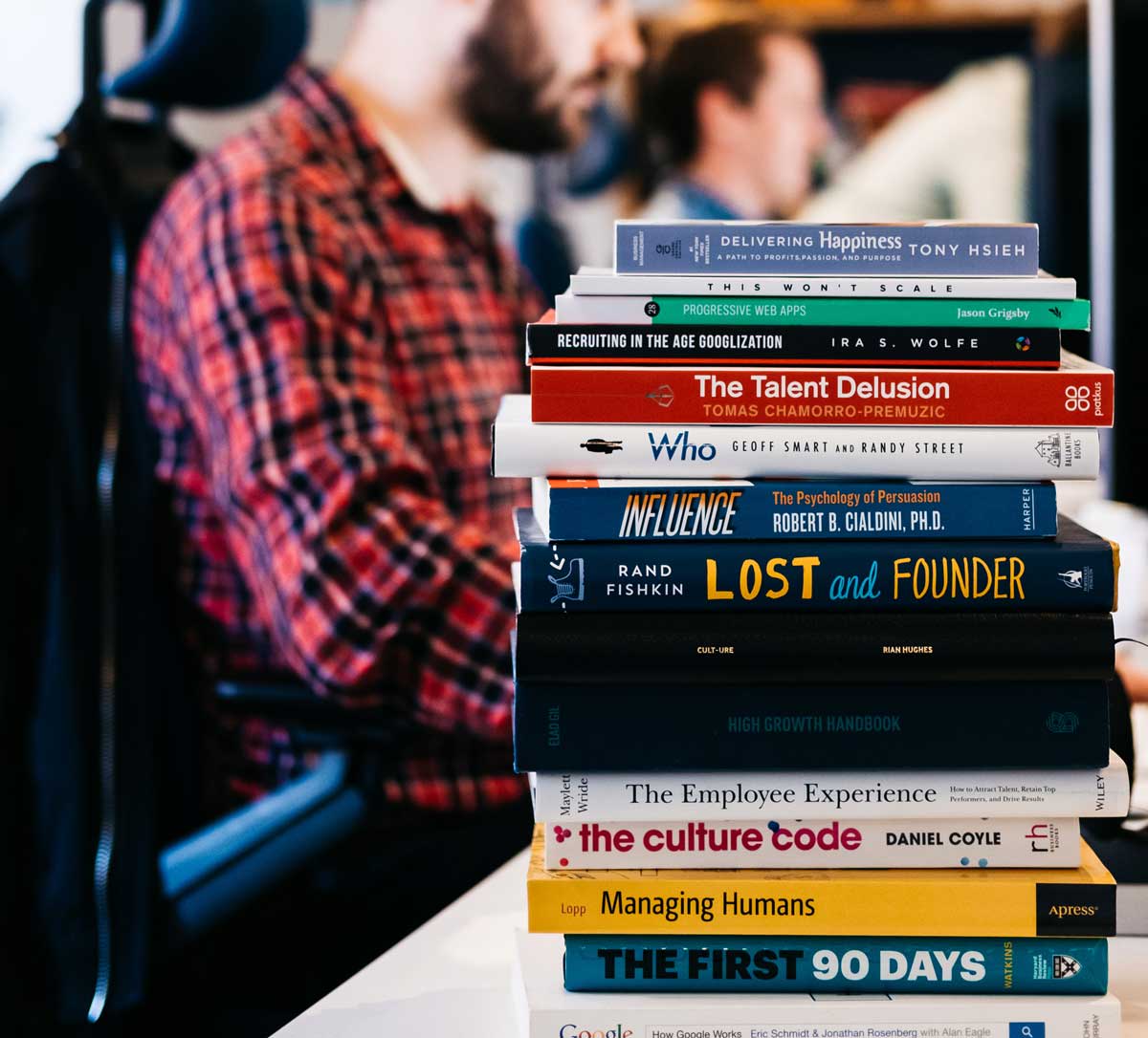 Stack of books on a desk in the Pinpoint office