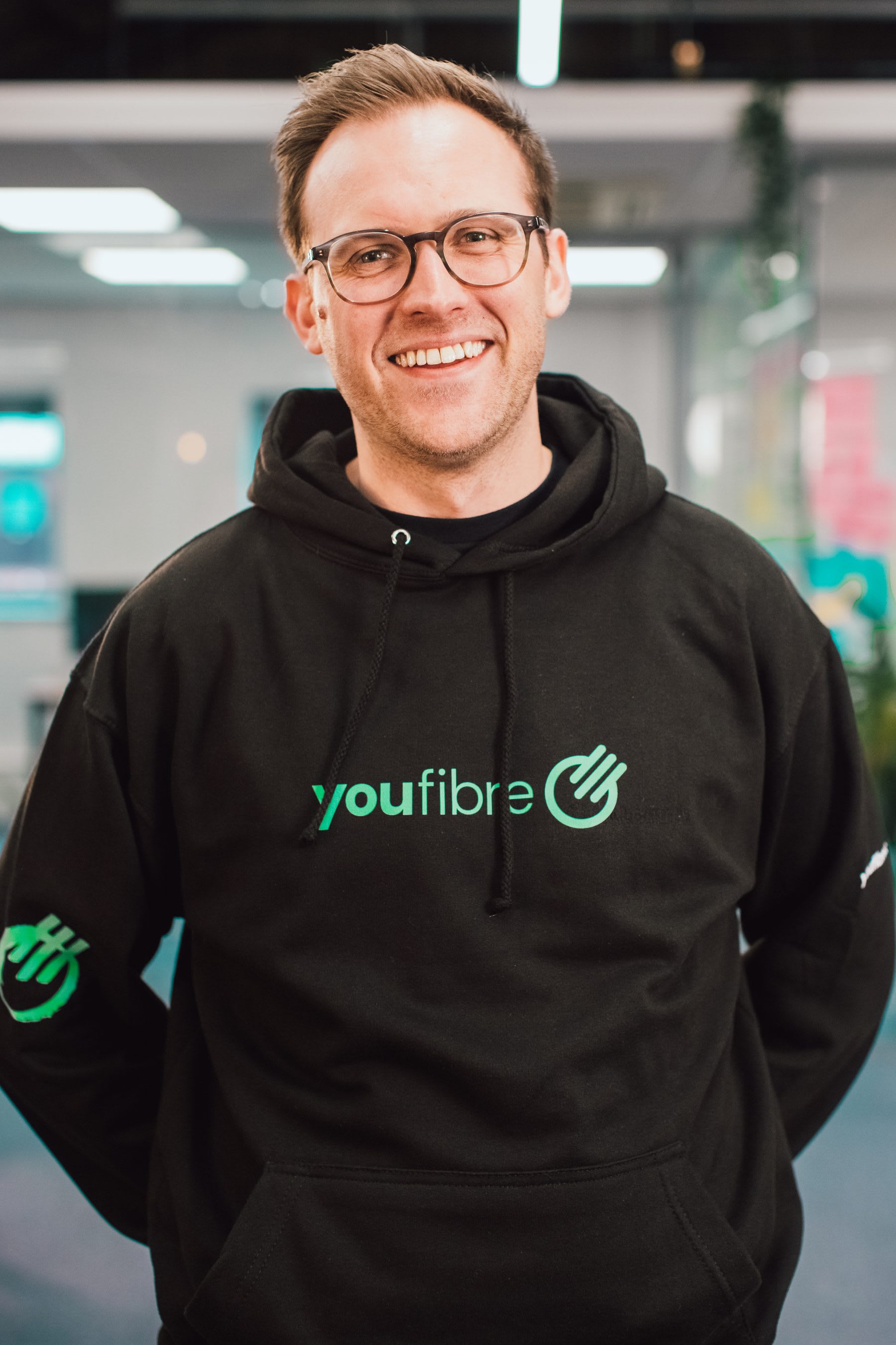 A YouFibre colleague smiling in the office