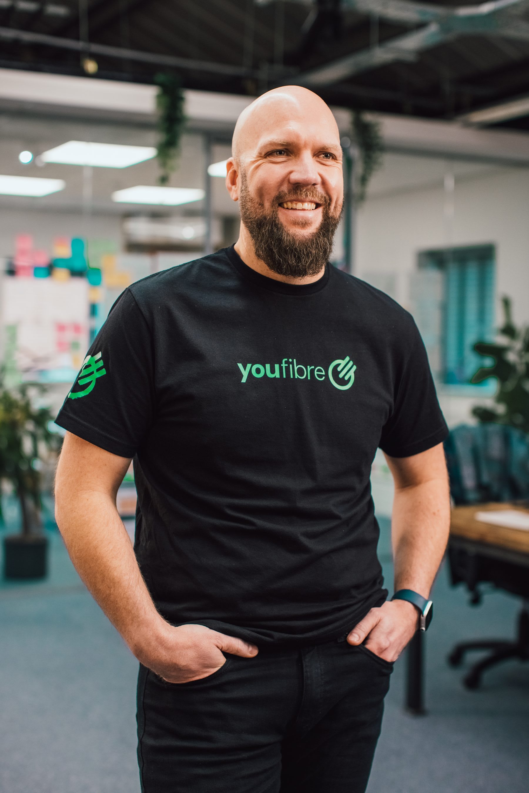 A YouFibre colleague in a branded t-shirt in the office
