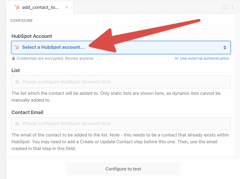 A screenshot of a user interface for adding a contact to a HubSpot account, with a prominent red arrow pointing to a dropdown menu titled "Select a HubSpot account...".