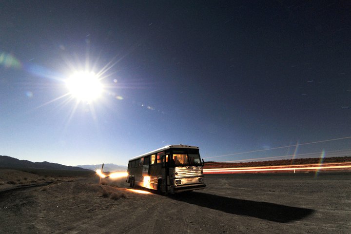 Stella the bus at midnight under a desert full moon