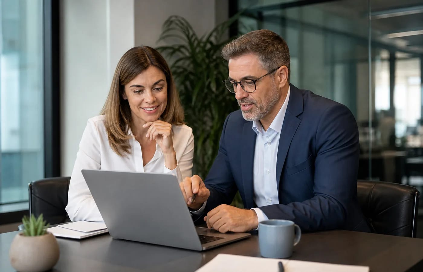 Business client and web strategist reviewing a live website together in a meeting room