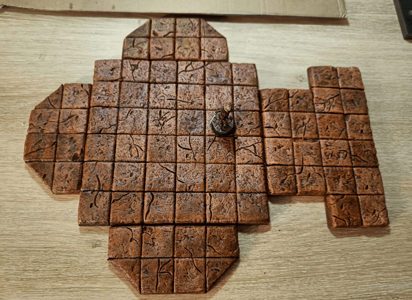 Miniature on tile showing scale and proper fit