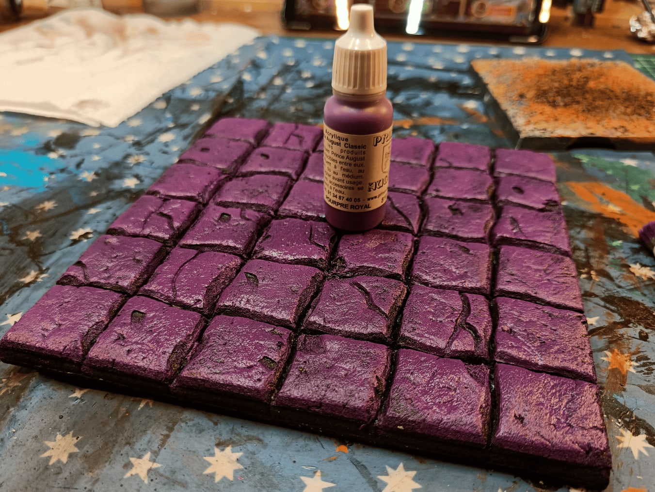 Tiles painted with purple tones for variation