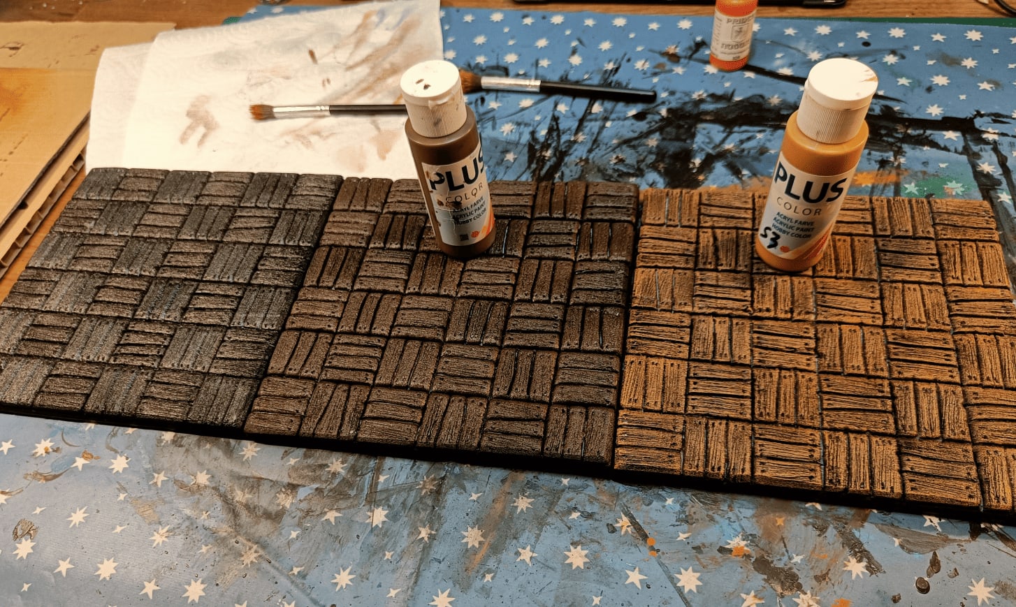 Three versions showing dark brown overbrush and progressive light brown drybrushing
