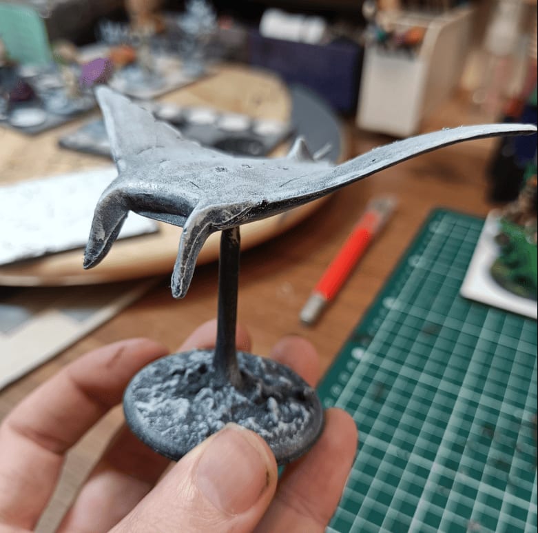 Plastic toy manta ray with visible mold lines painted as cloaker