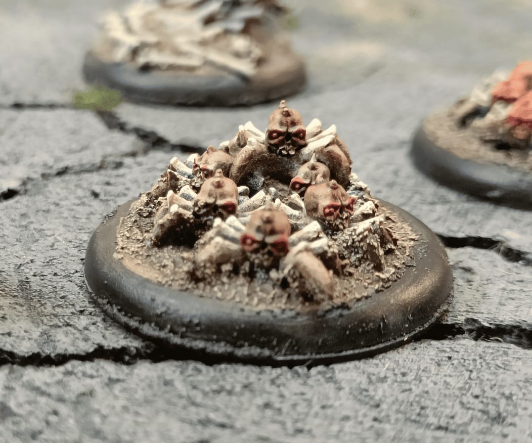 Close-up of spider-skull miniatures with legs