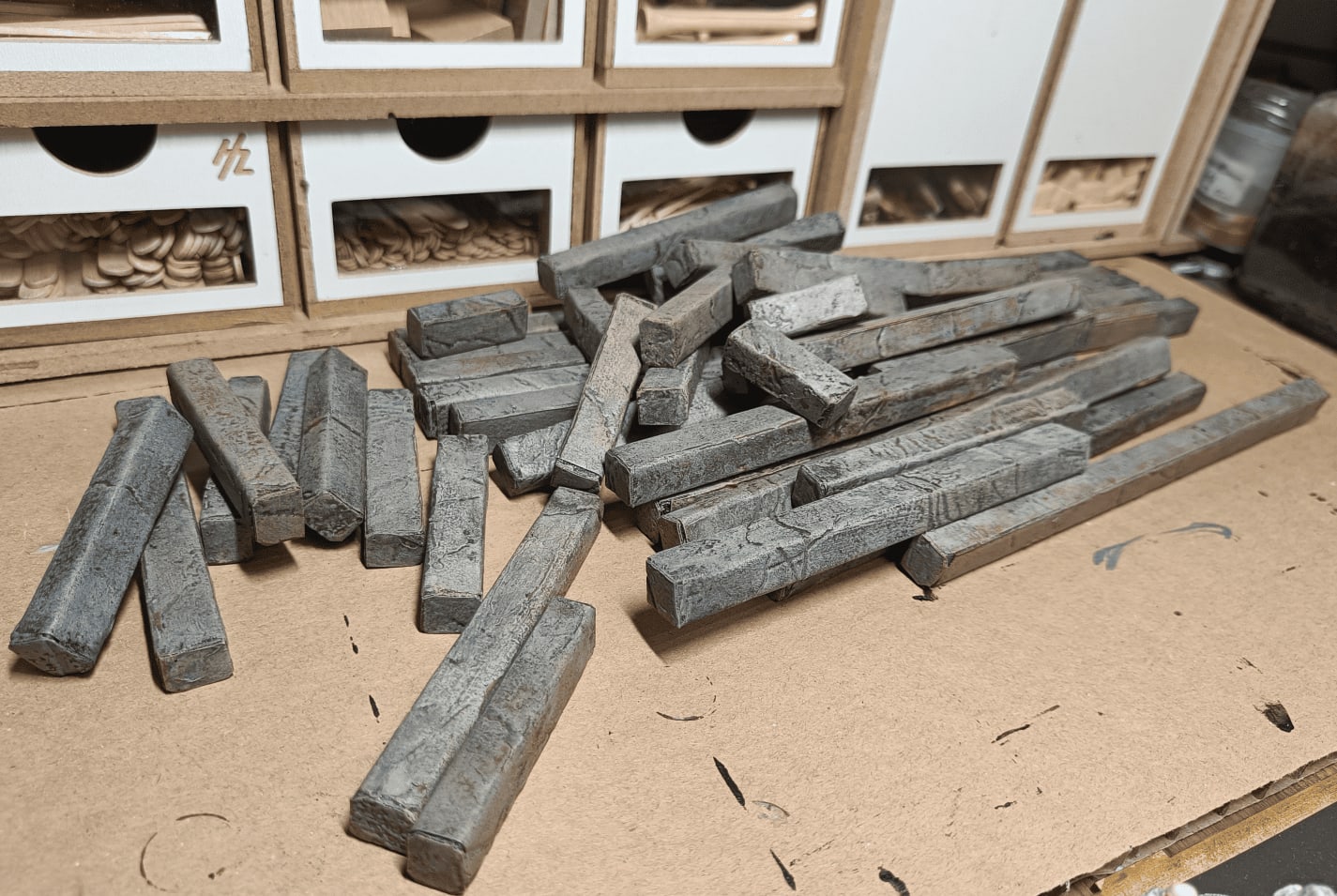 Finished modular stone walls made from wooden sticks with miniature for scale