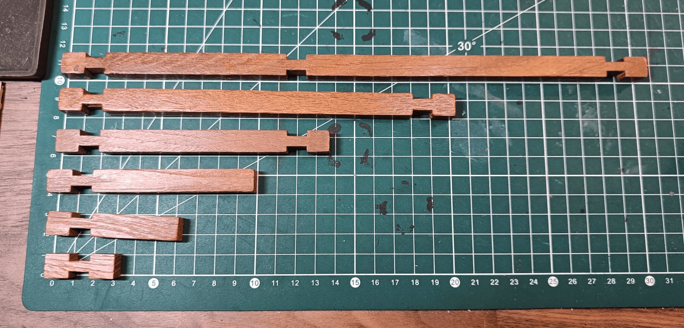 Different sizes of wooden sticks arranged showing their lengths