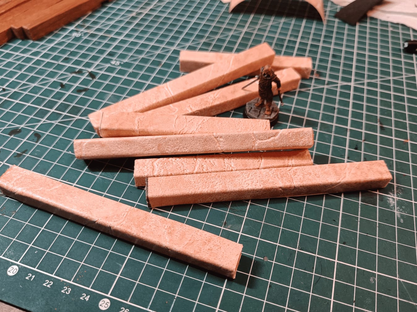 Process of wrapping wooden stick with wallpaper using wood glue