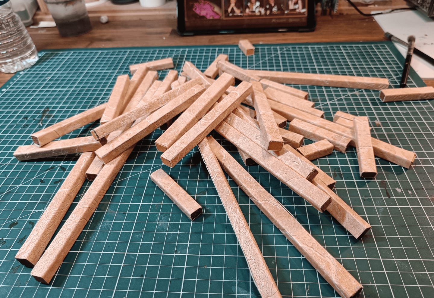 Wrapped sticks with excess wallpaper at the ends