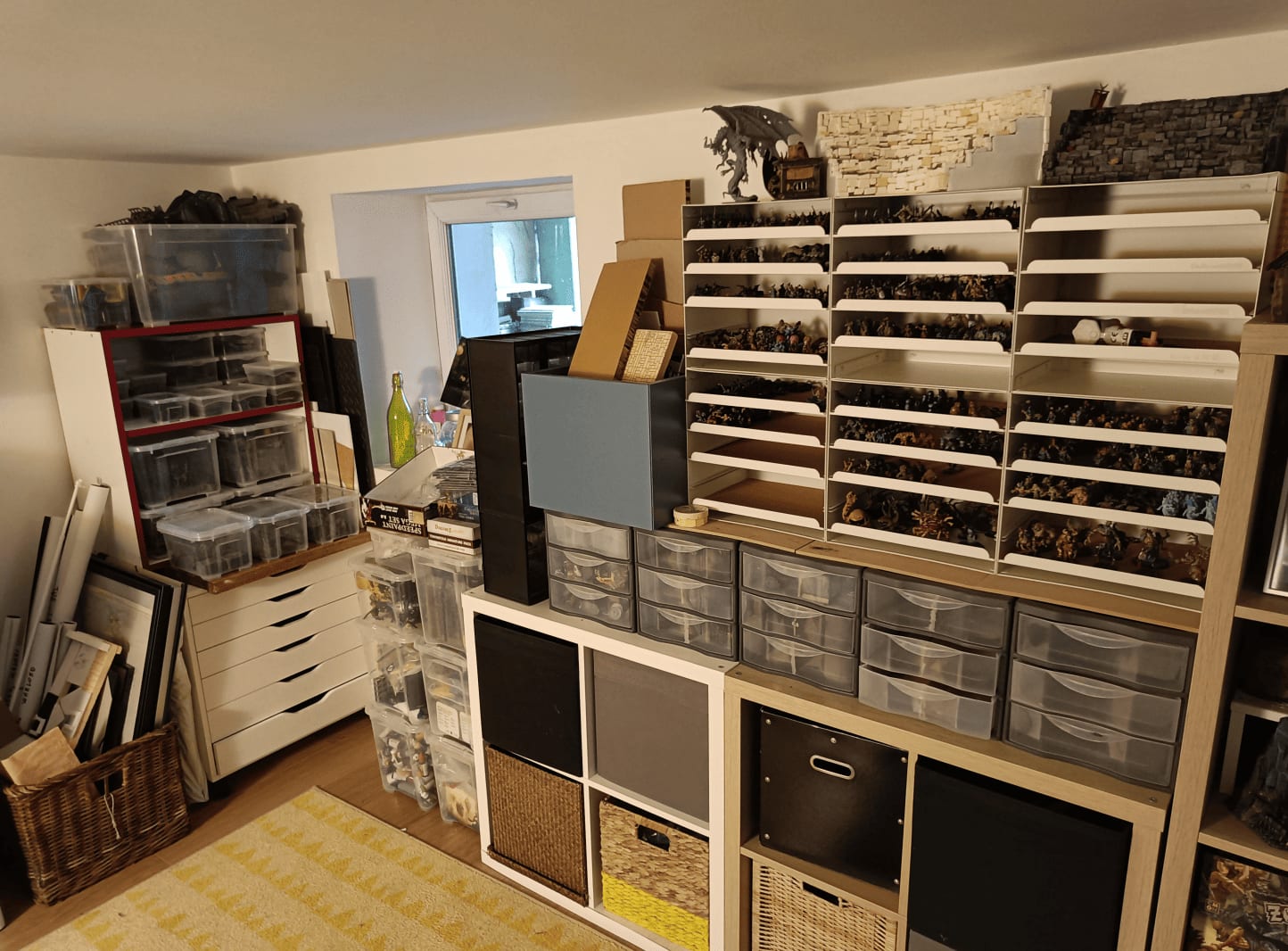 Basement corner with white shelving and IKEA storage bins