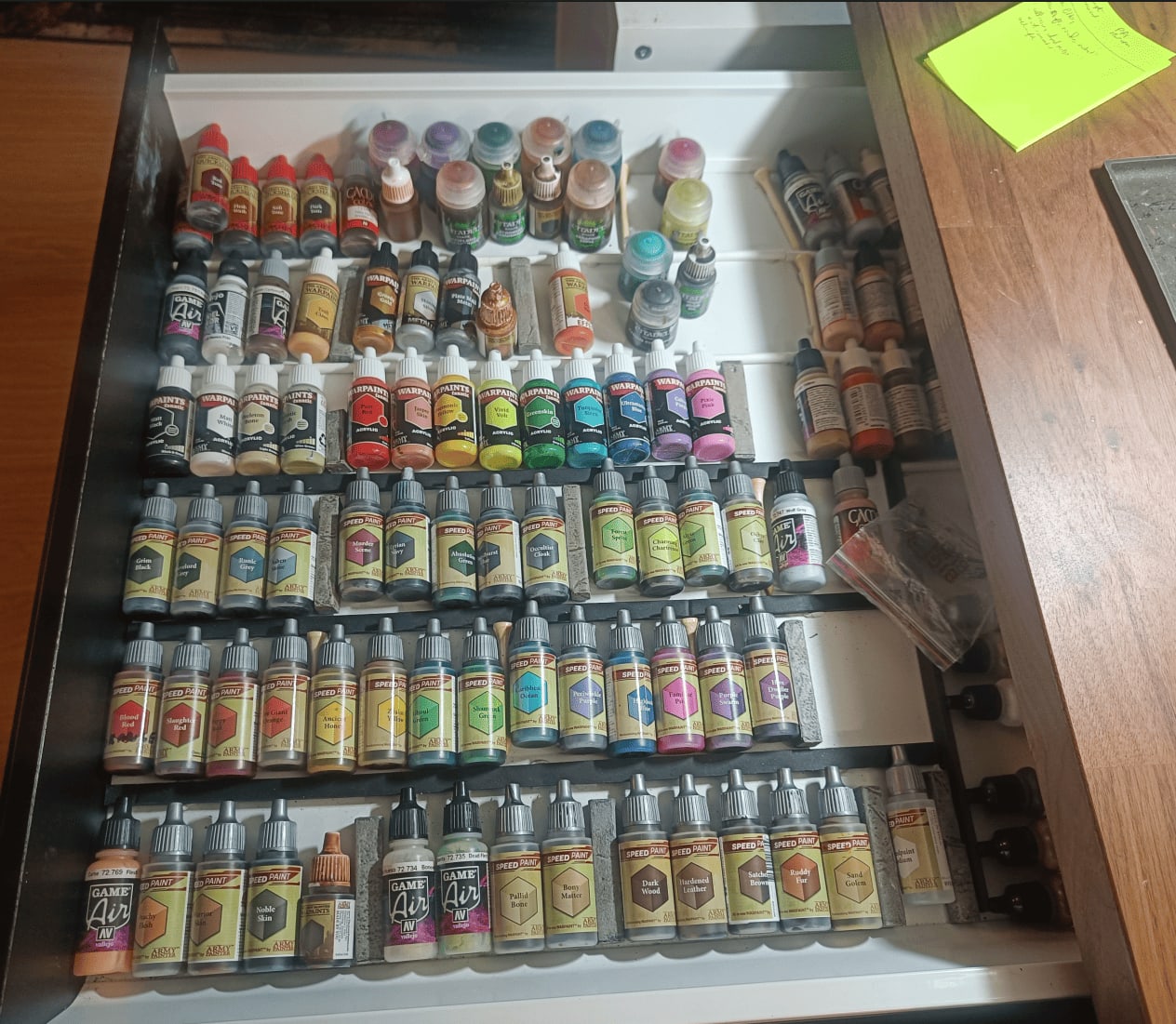 Paint drawer organized with cardboard dividers by color and type