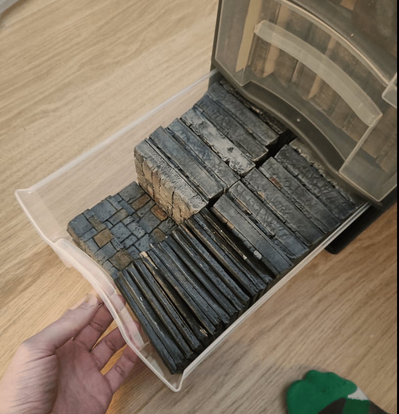 Drawer filled with stone floor tiles and water tiles for Zombicide scenarios