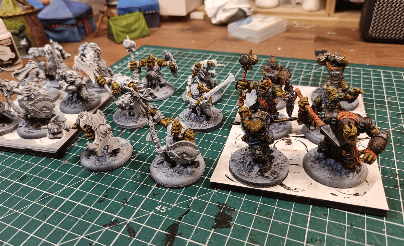 Three batches showing primed, skin painted in Ochre Clay, and detailed stages