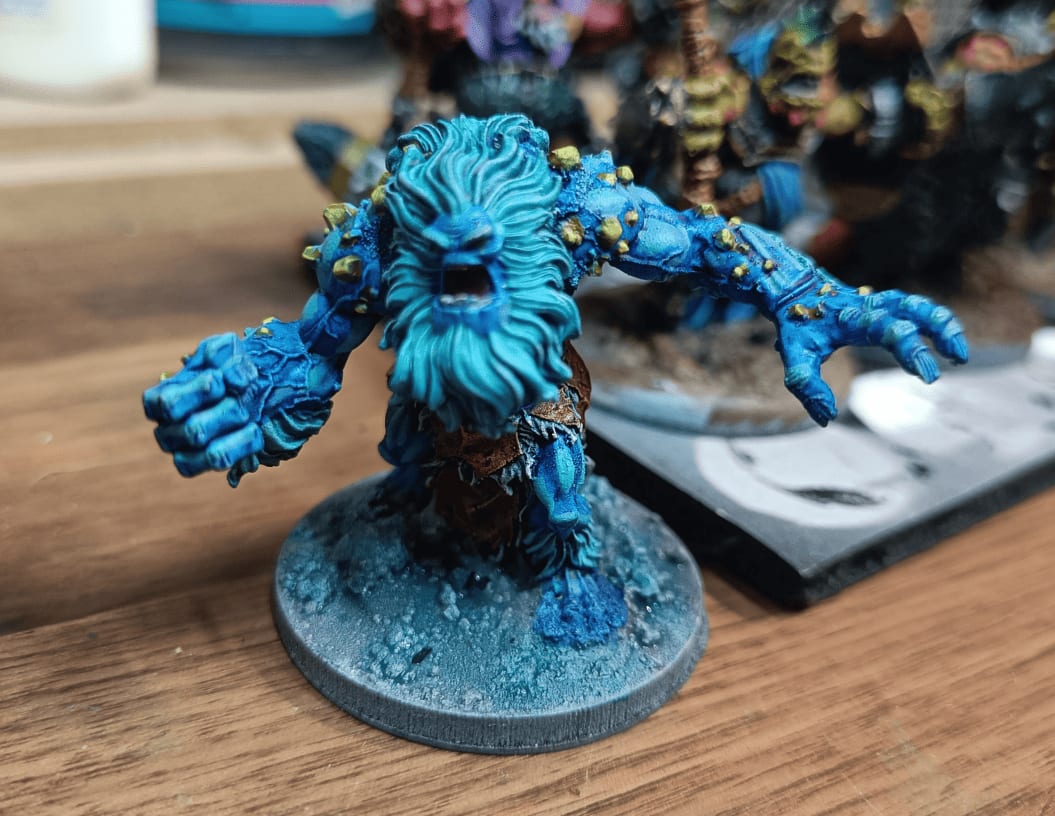 Yeti with yellow stone shards painted over blue base