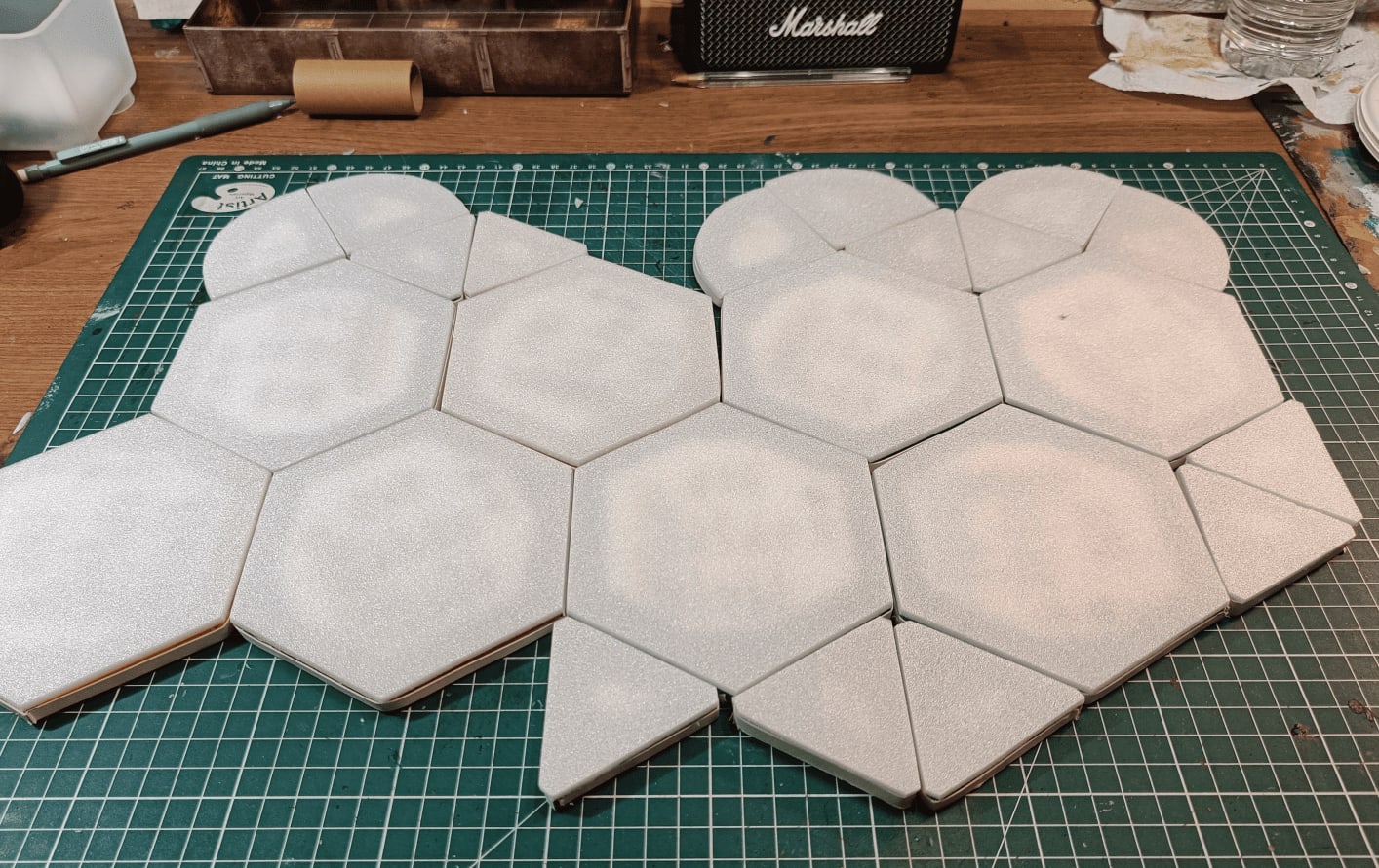 Array of cut pieces showing hexagonal, square, and curved tiles