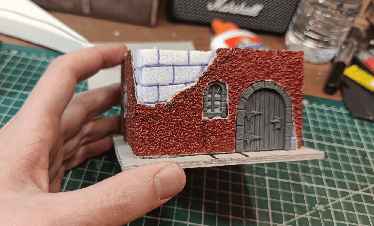 House with sandpaper texture layer glued back over walls