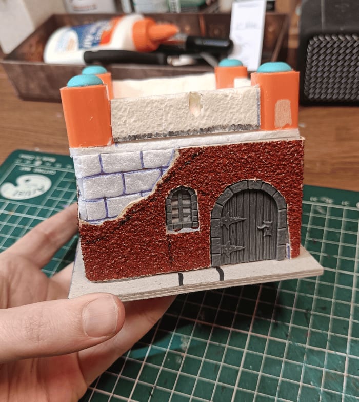 Roof with chunky parapet made from medicine tubes and domes