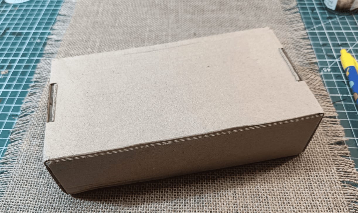 Large cardboard box used as base for longer building structure