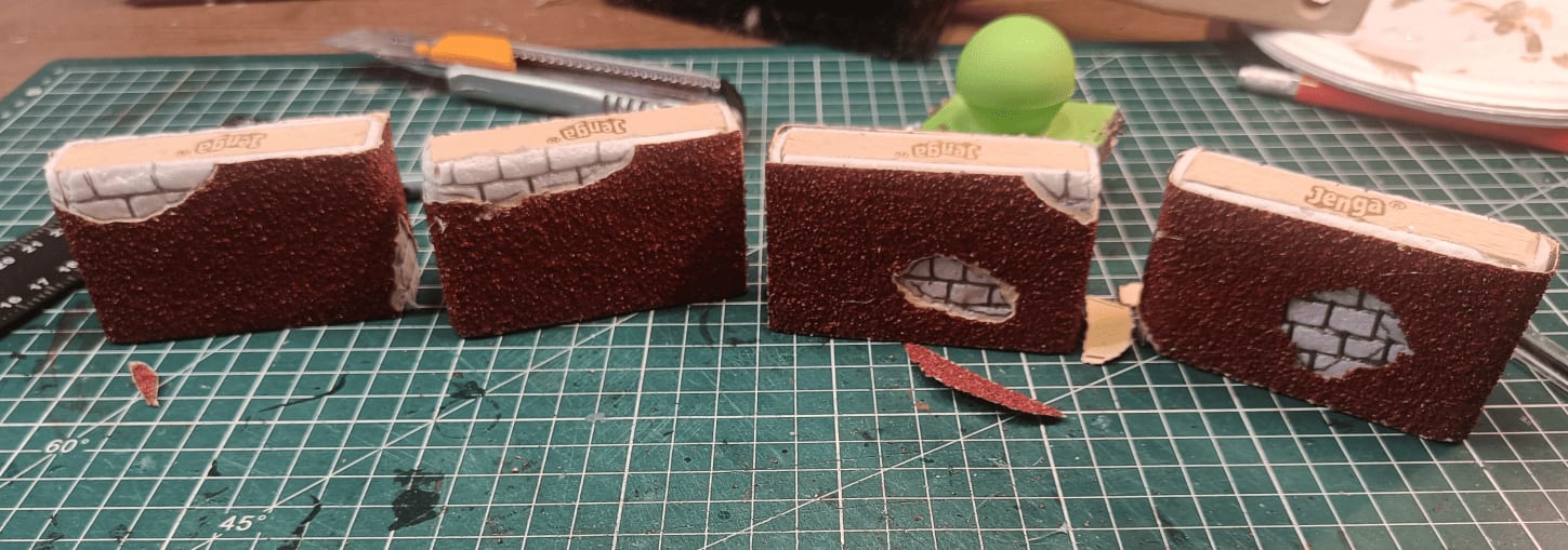 Multiple wall pieces with Jenga blocks, foam and sandpaper layers