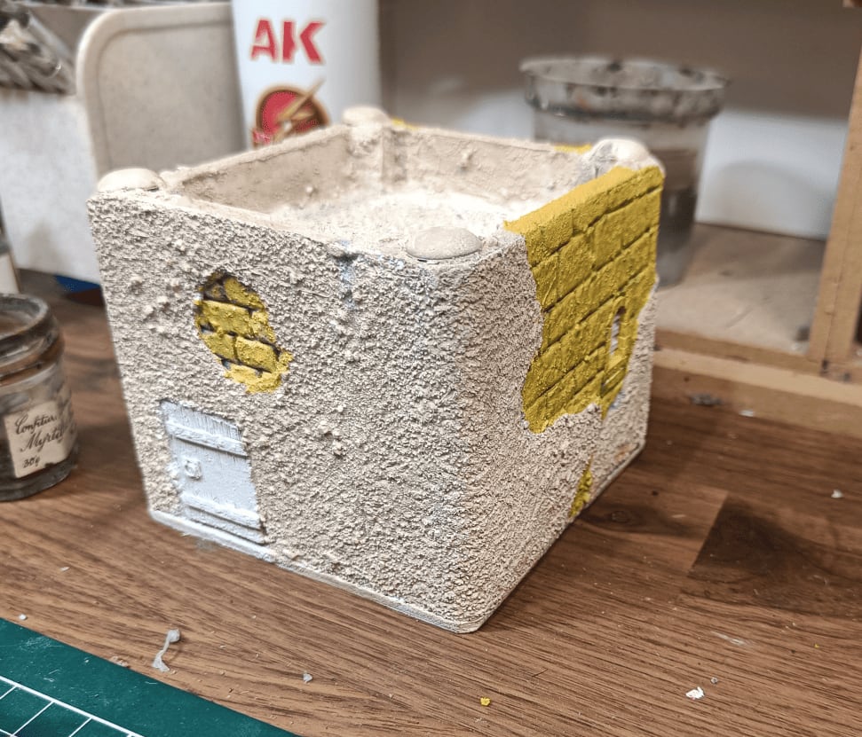 Building details painted in yellow ochre highlighting stone features